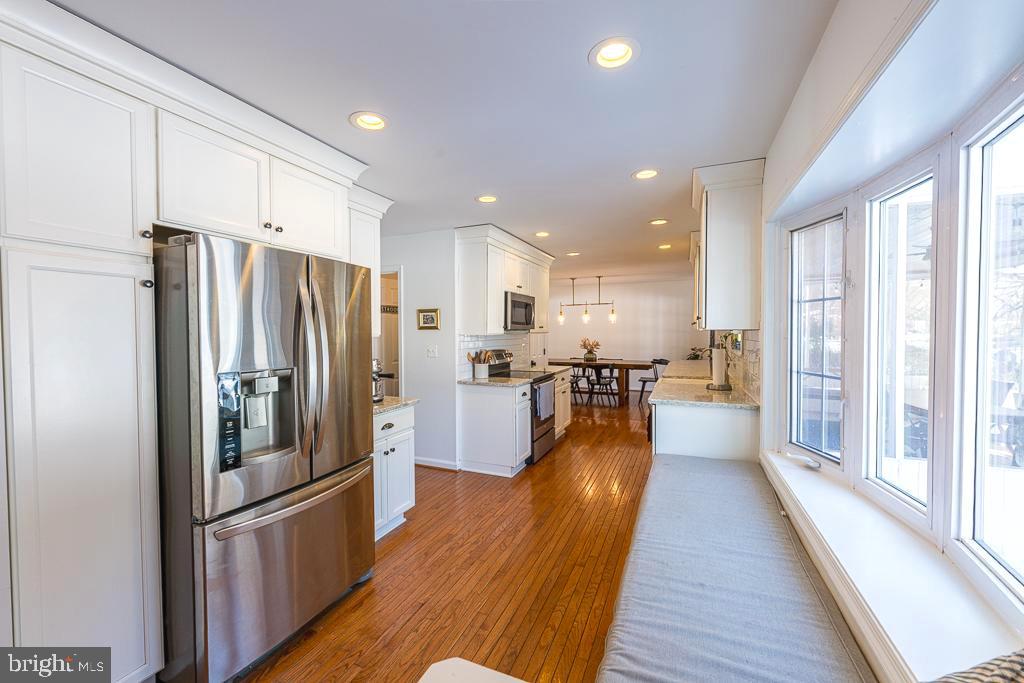 2510 Little River Road Haymarket, VA 20169 - Photo 12 of 39 a kitchen with stainless steel appliances a refrigerator a stove top oven and wooden floor