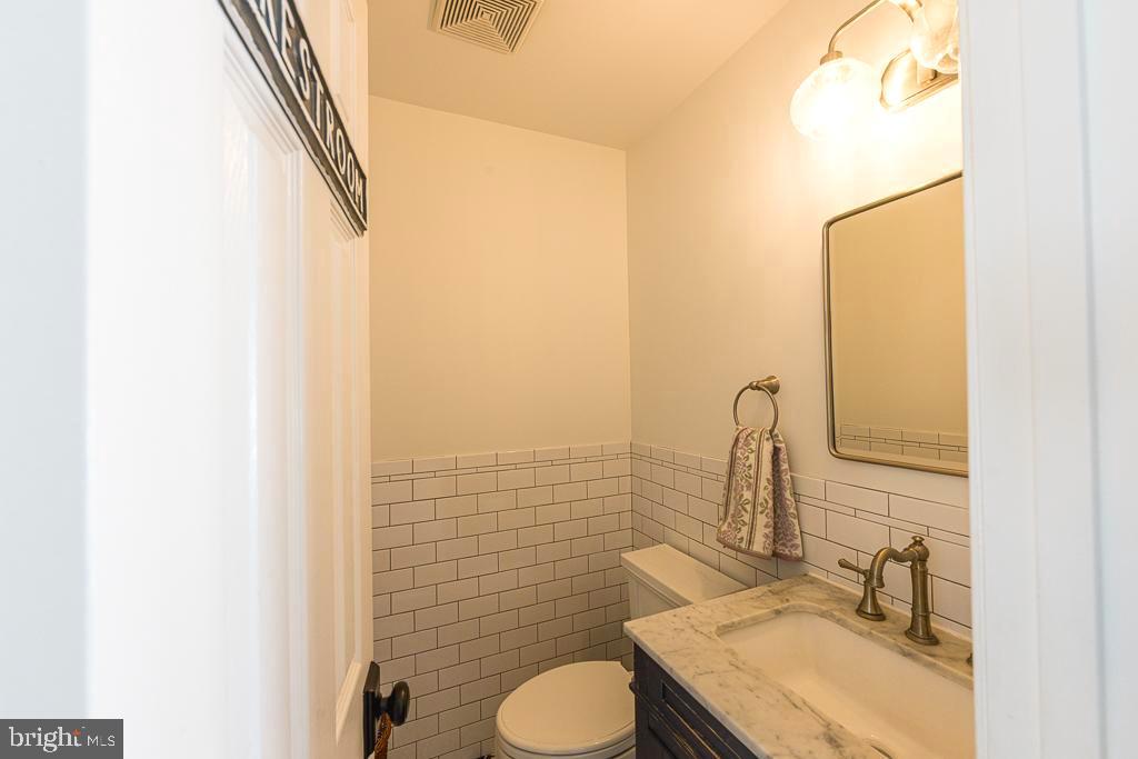 2510 Little River Road Haymarket, VA 20169 - Photo 18 of 39 a bathroom with a granite countertop sink toilet and mirror