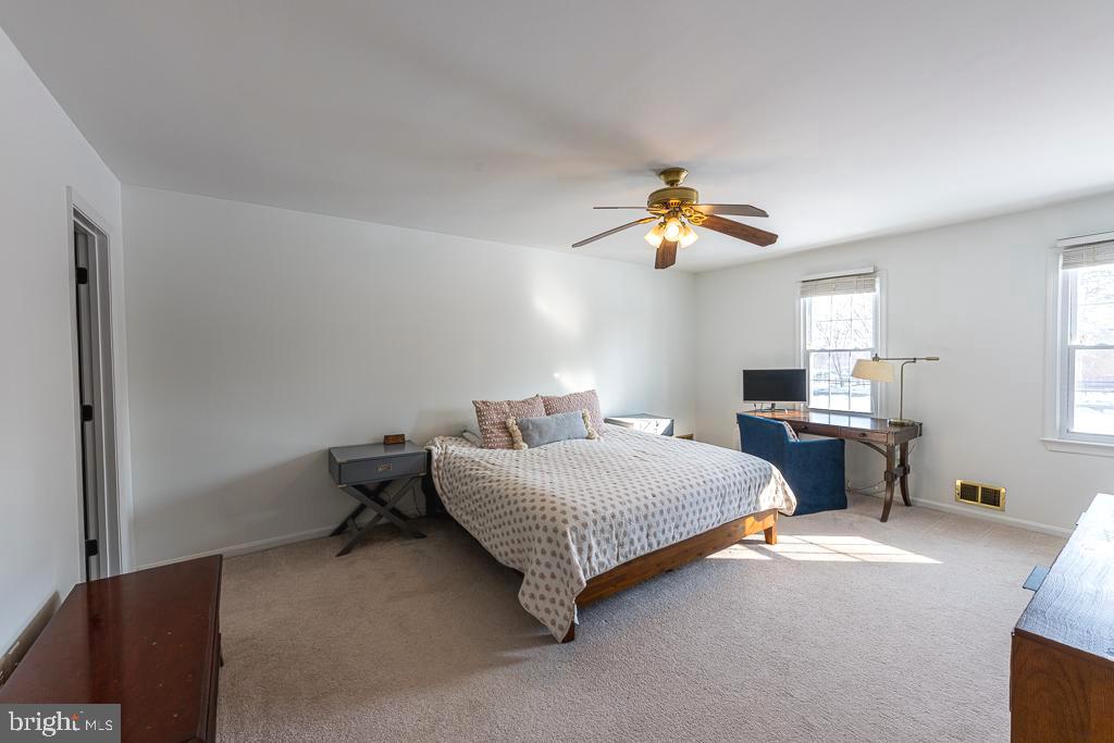 2510 Little River Road Haymarket, VA 20169 - Photo 20 of 39 a bedroom with a bed and a chandelier