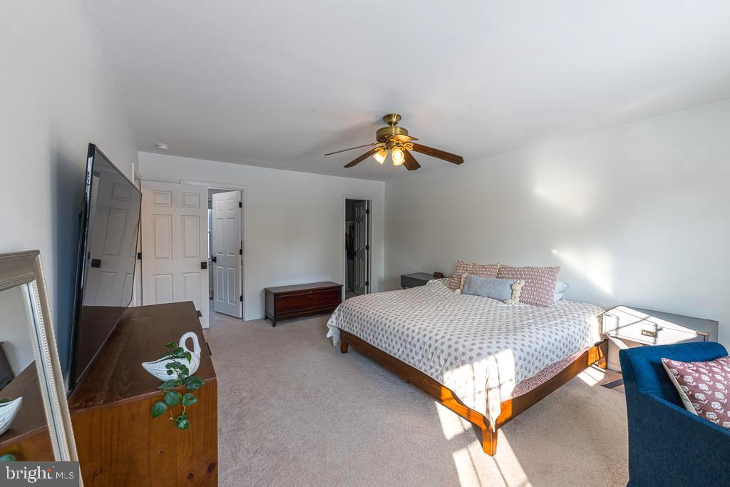 2510 Little River Road Haymarket, VA 20169 - Photo 22 of 39 a bedroom with a bed and a chandelier