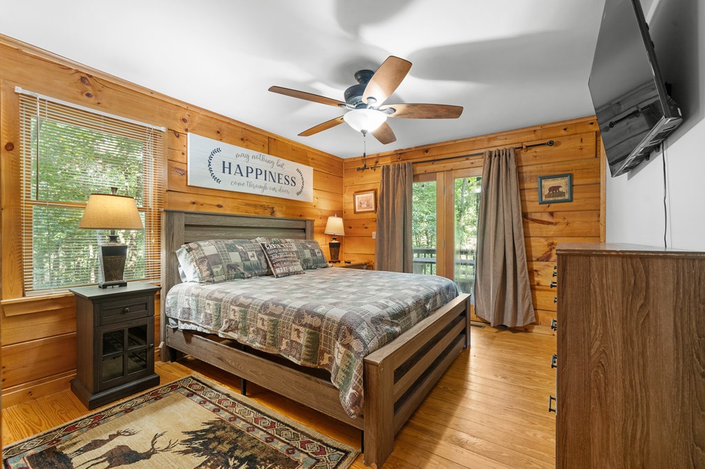 93 Amy Lane Ellijay, GA 30540 - Photo 20 of 61 a bedroom with a large bed and a chandelier