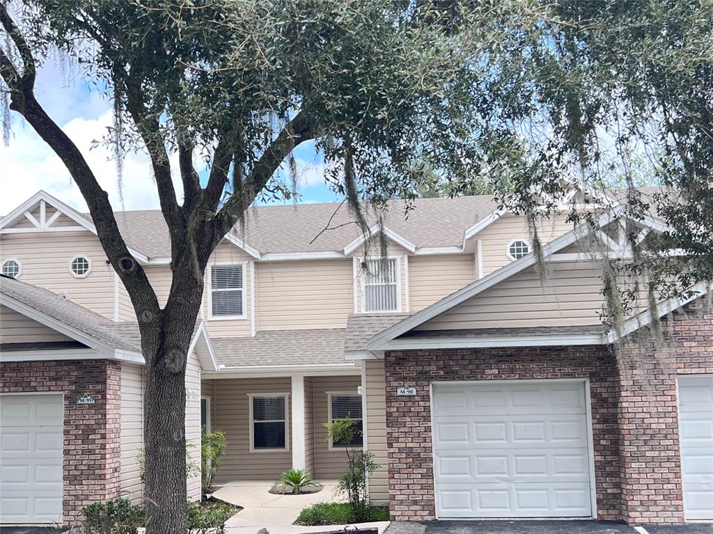 4700 Southwest Archer Road, Unit M90 Gainesville, FL 32608 - Photo 1 of 35 a view of a white house with large tree