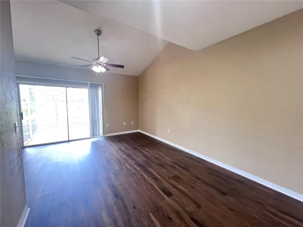4700 Southwest Archer Road, Unit M90 Gainesville, FL 32608 - Photo 13 of 35 a view of an empty room with wooden floor and a window