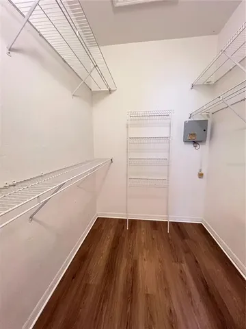 a view of walk in closet with empty racks