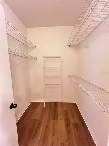 a view of a room with wooden floor