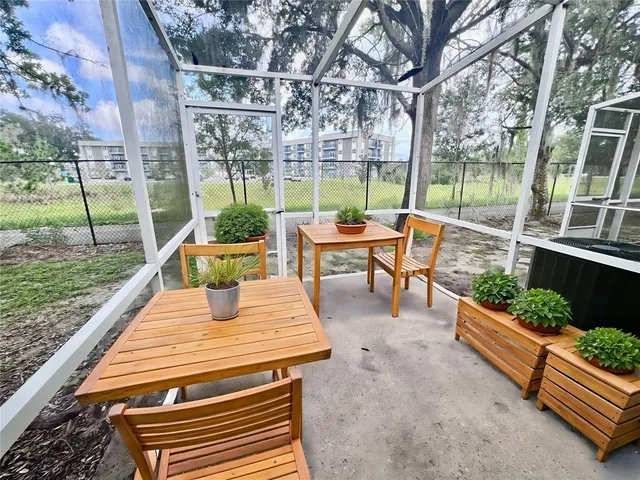 a view of a patio with a table chairs and a backyard