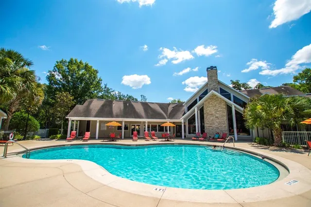 a view of house with swimming pool outdoor seating