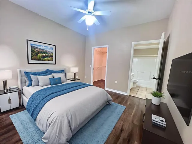 a bedroom with bed and a chandelier