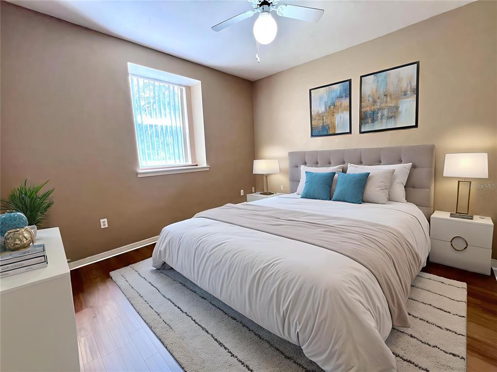 4700 Southwest Archer Road, Unit M90 Gainesville, FL 32608 - Photo 5 of 35 a bedroom with a bed lamp and a potted plant