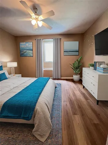 a spacious bedroom with a bed and a flat screen tv