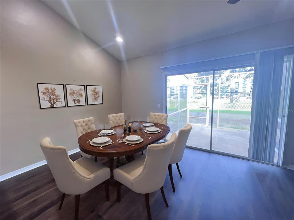 4700 Southwest Archer Road, Unit M90 Gainesville, FL 32608 - Photo 7 of 35 a view of a dining room with furniture and wooden floor