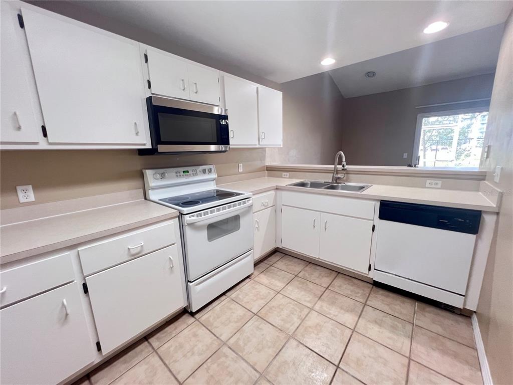 4700 Southwest Archer Road, Unit M90 Gainesville, FL 32608 - Photo 9 of 35 a kitchen with a sink stove and microwave