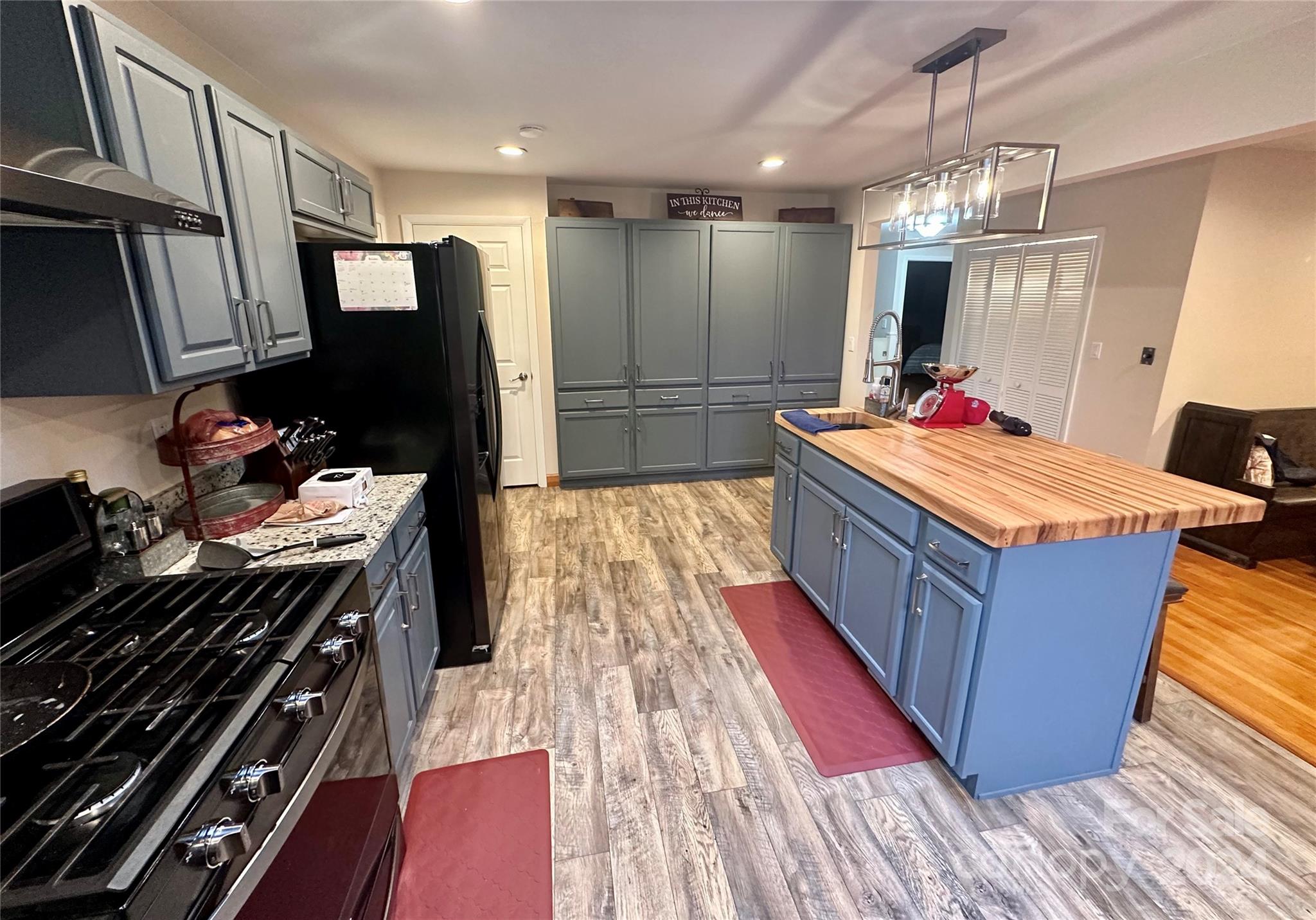 4108 Johnson Road Jefferson, SC 29718 - Photo 11 of 39 a kitchen with wooden floor a stove and a refrigerator