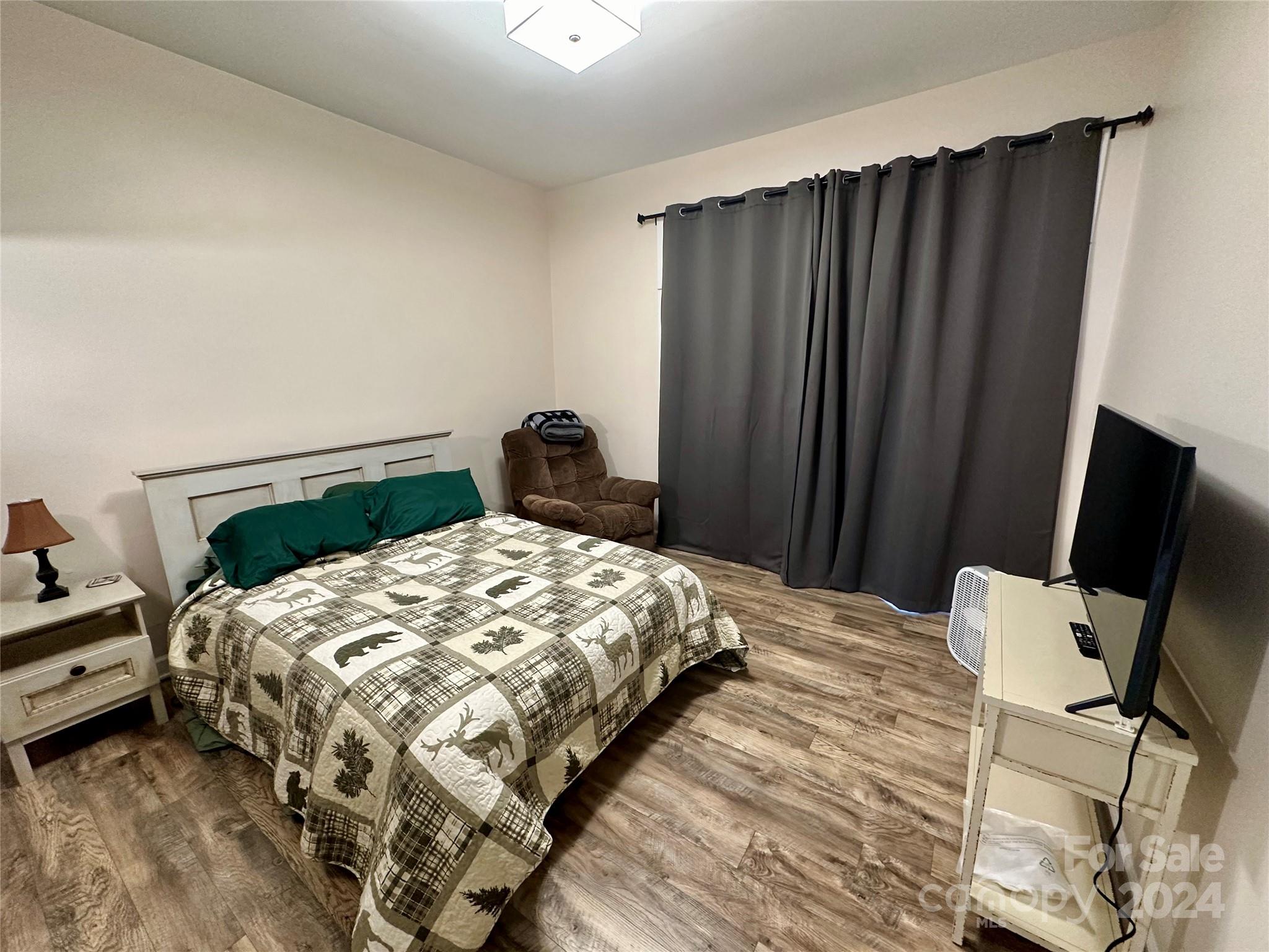 4108 Johnson Road Jefferson, SC 29718 - Photo 23 of 39 a bedroom with a bed and wooden floor