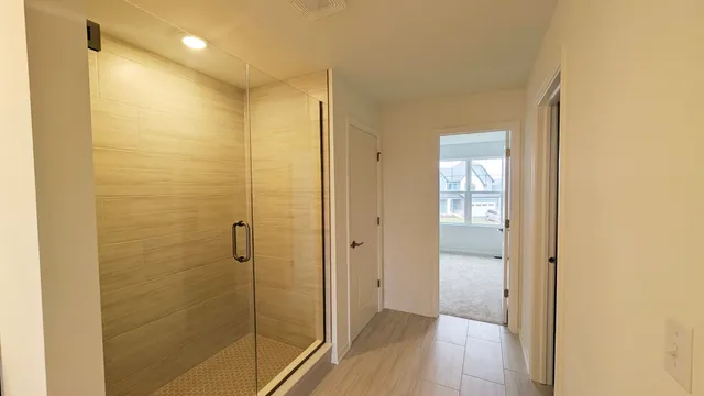 a bathroom with a shower and a glass door