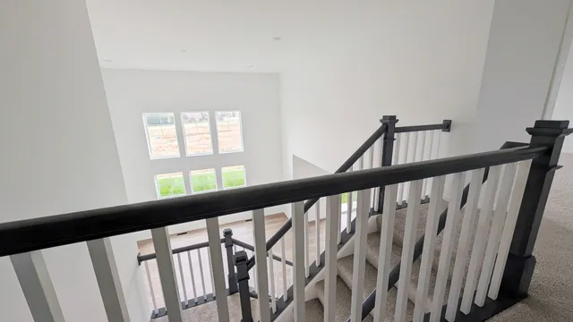 a view of staircase with rug