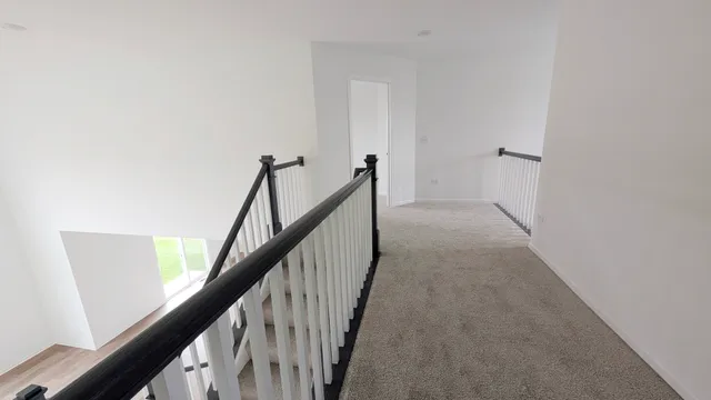 a view of a hallway with stairs
