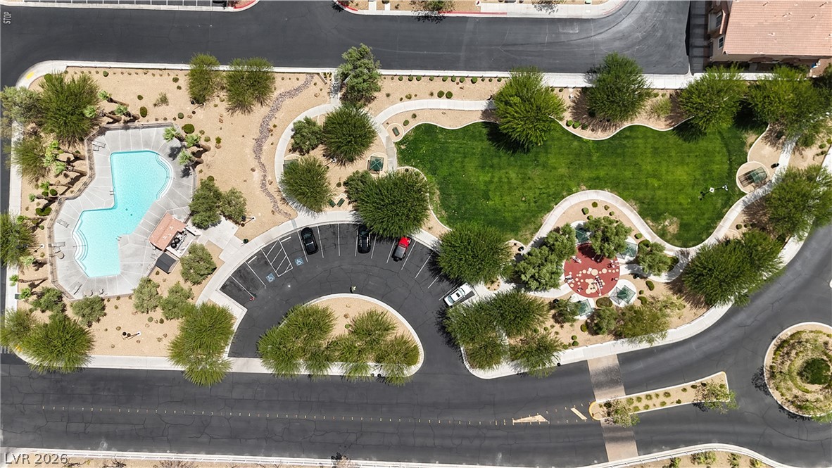 8934 Deep Ridge Court Las Vegas, NV 89178 - Photo 34 of 47 An aerial perspective reveals a vibrant community area featuring a refreshing pool, lush green spaces, and dedicated parking.