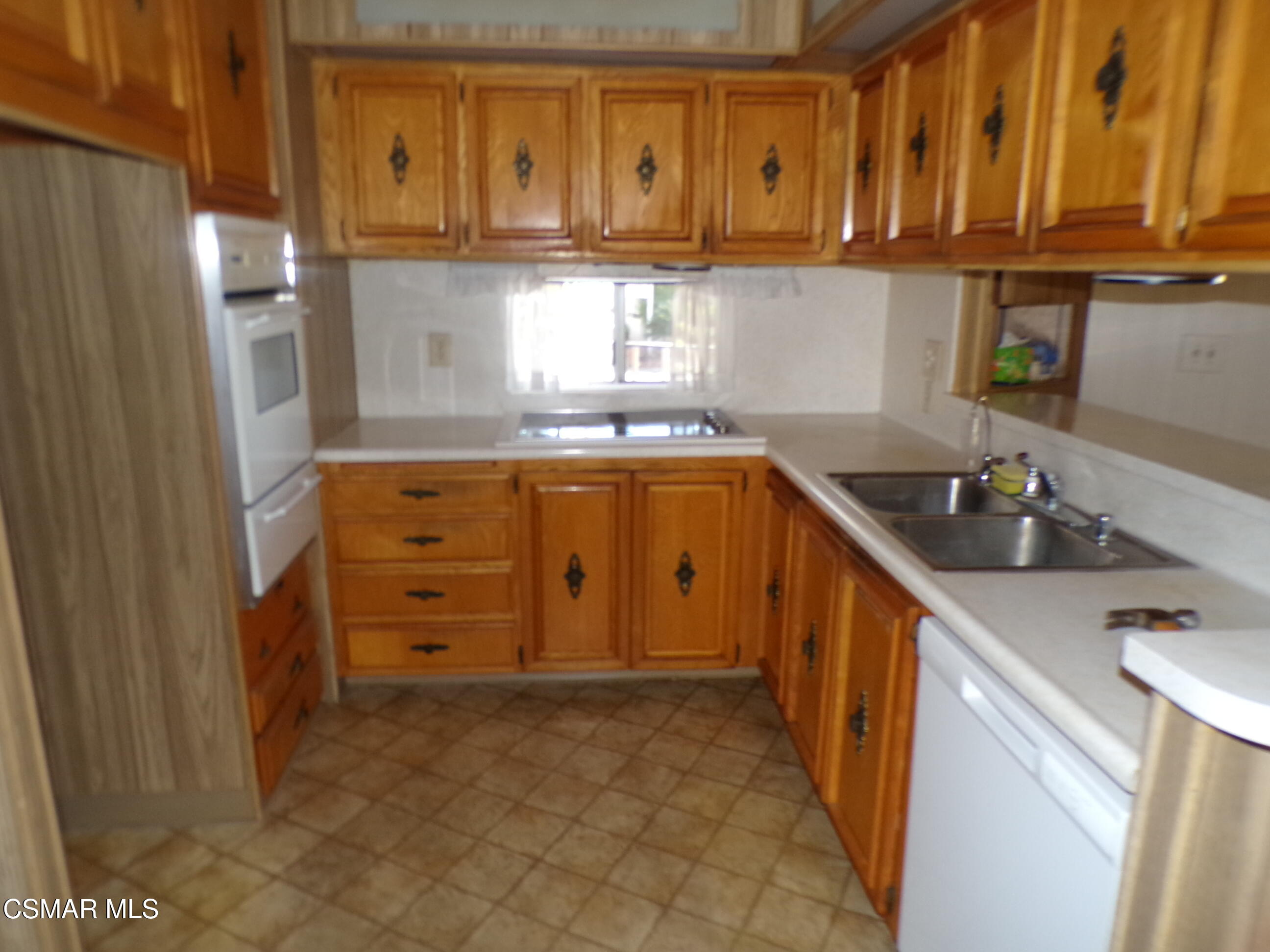 250 East Telegraph Road, Unit 220 Fillmore, CA 93015 - Photo 11 of 24 a kitchen with granite countertop a sink and cabinets