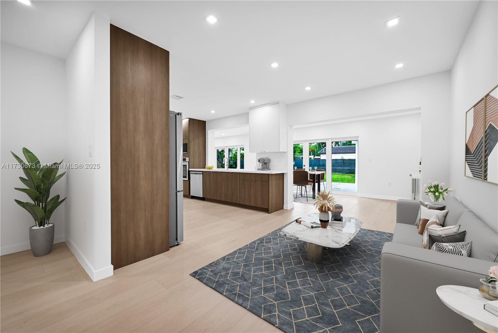 8745 Southwest 175th Street Palmetto Bay, FL 33157 - Photo 2 of 37 a living room with furniture and a potted plant