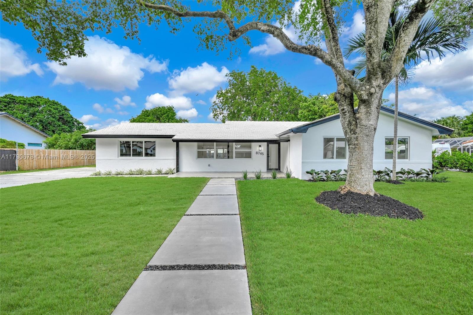 8745 Southwest 175th Street Palmetto Bay, FL 33157 - Photo 23 of 37 a view of a house with a yard