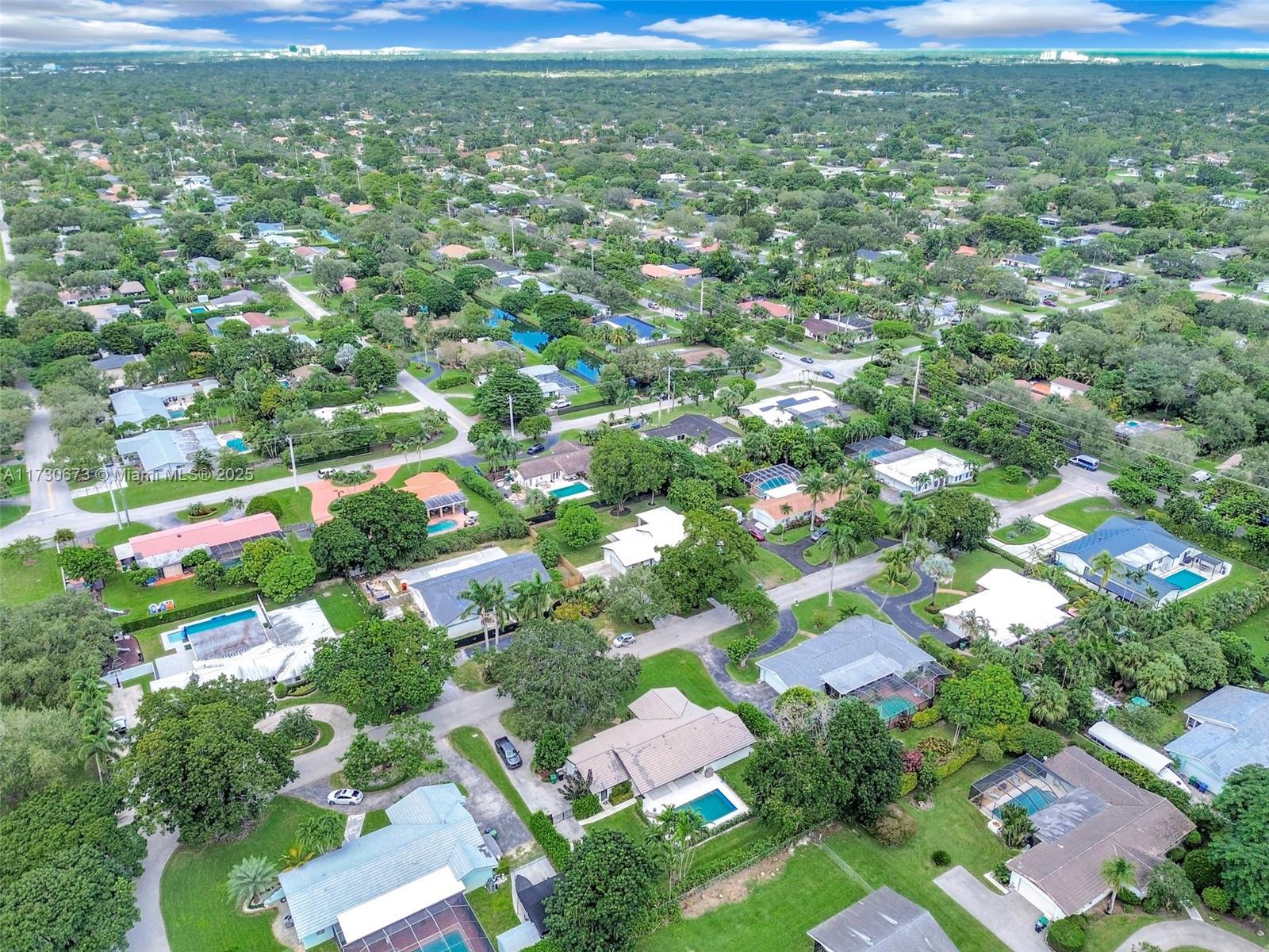 8745 Southwest 175th Street Palmetto Bay, FL 33157 - Photo 33 of 37 an aerial view of residential houses with outdoor space and trees