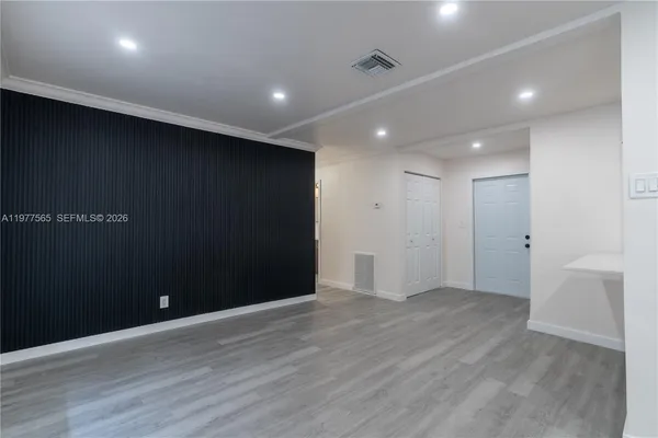an empty room with wooden floor