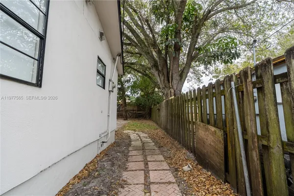 a view of a pathway both side of house