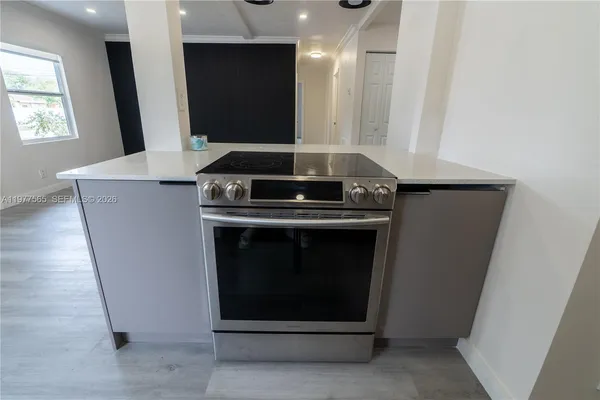 a stove top oven sitting inside of a kitchen