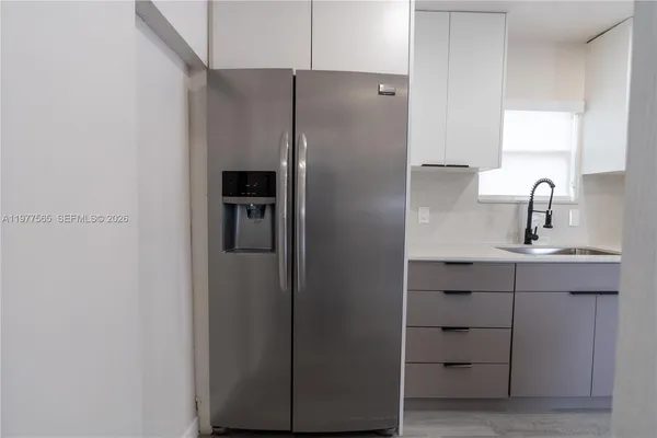 a kitchen with a refrigerator and sink