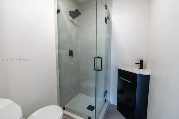 a bathroom with a shower and toilet