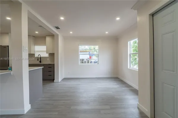 wooden floor in kitchen and a big room with windows