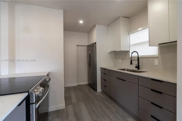 a kitchen with a sink and a refrigerator