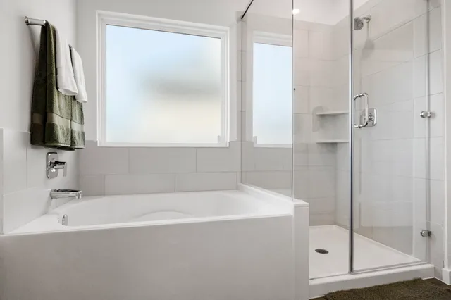 a bathroom with a bathtub and a shower