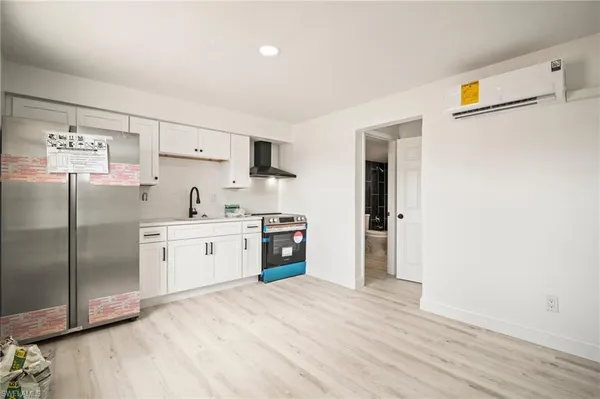 a kitchen with stainless steel appliances a refrigerator sink and cabinets