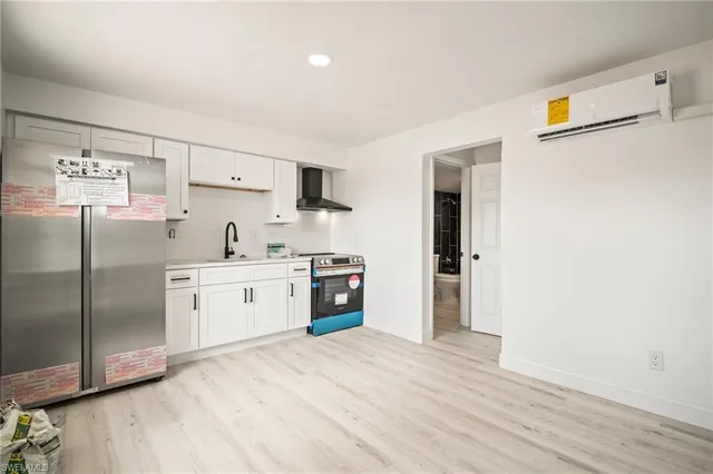 a kitchen with stainless steel appliances a refrigerator sink and cabinets