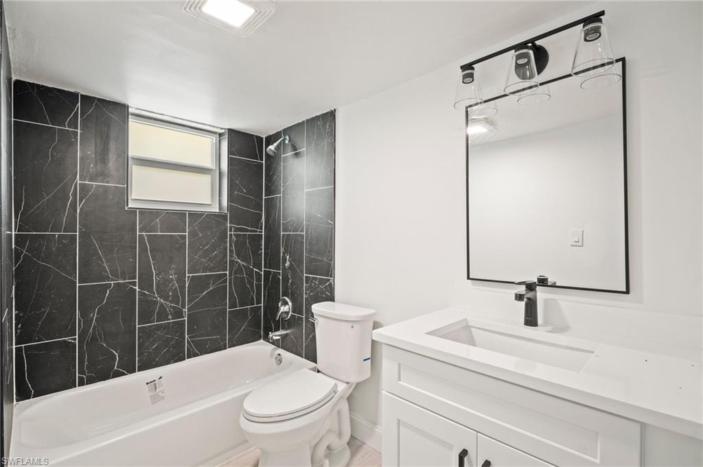 2316 Bayside Street Naples, FL 34112 - Photo 18 of 24 a bathroom with a sink a toilet and shower