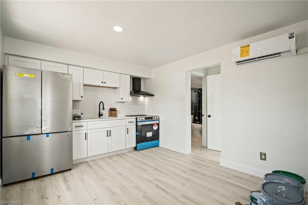 2316 Bayside Street Naples, FL 34112 - Photo 20 of 24 a kitchen with stainless steel appliances granite countertop a refrigerator and a stove top oven