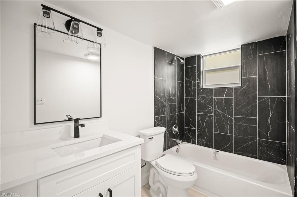 2316 Bayside Street Naples, FL 34112 - Photo 23 of 24 a bathroom with a sink a toilet and shower