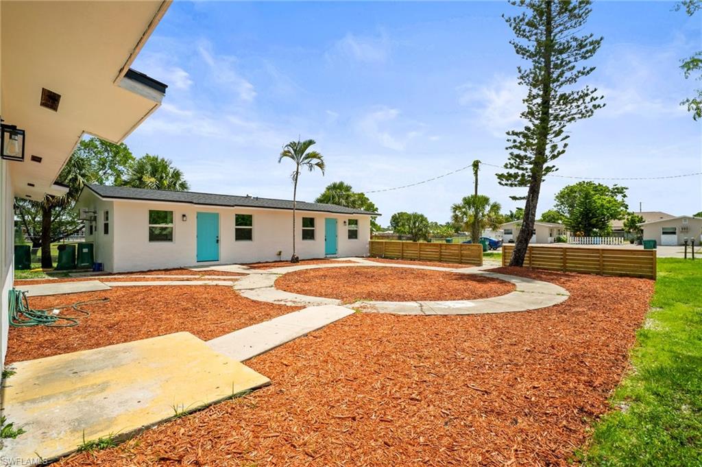 2316 Bayside Street Naples, FL 34112 - Photo 3 of 24 a view of a white house with a yard