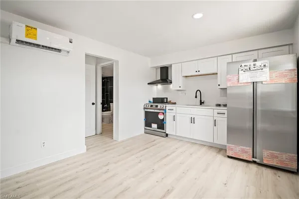a kitchen with stainless steel appliances a refrigerator sink and cabinets