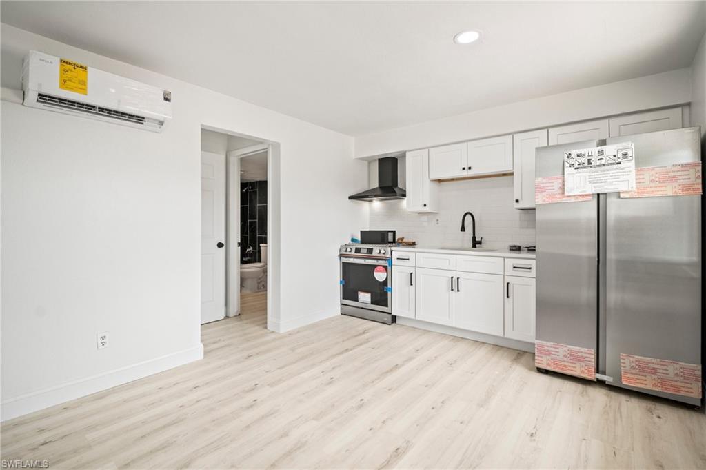 2316 Bayside Street Naples, FL 34112 - Photo 6 of 24 a kitchen with stainless steel appliances a refrigerator sink and cabinets