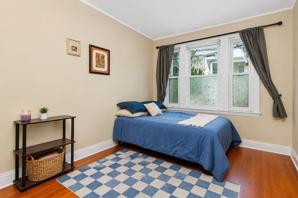 8 Colliston Road Boston, MA 02135 - Photo 16 of 40 a bedroom with a bed and a window