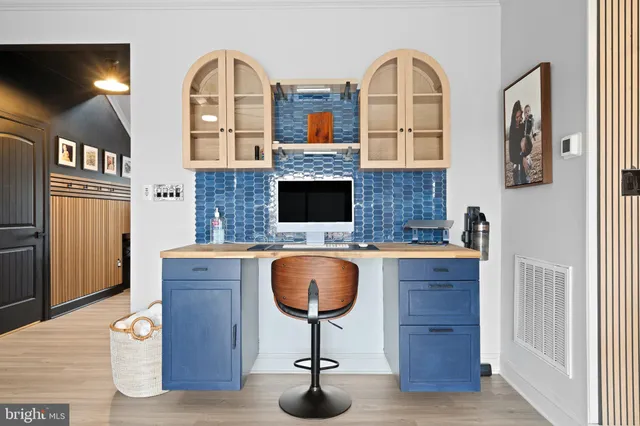 a living room with fireplace furniture and a wooden floor