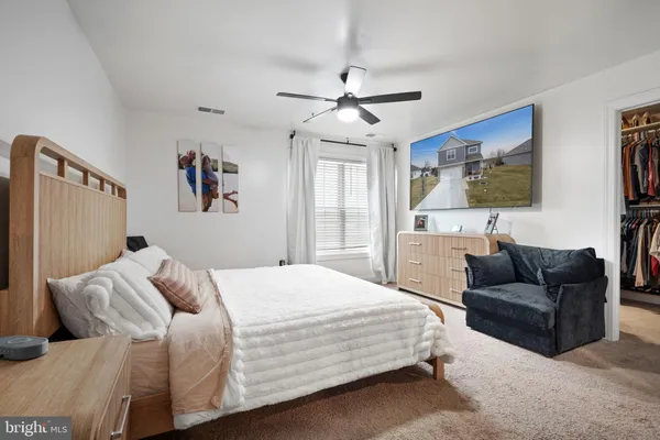 a bedroom with a bed couch and window