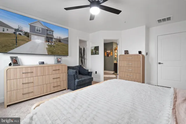 a bedroom with a bed and a dresser