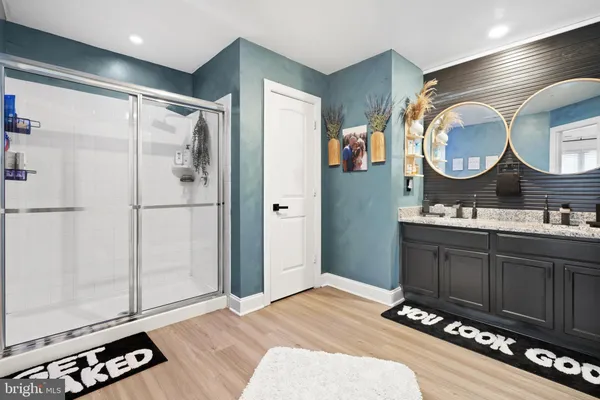 a bathroom with a double vanity sink and a mirror
