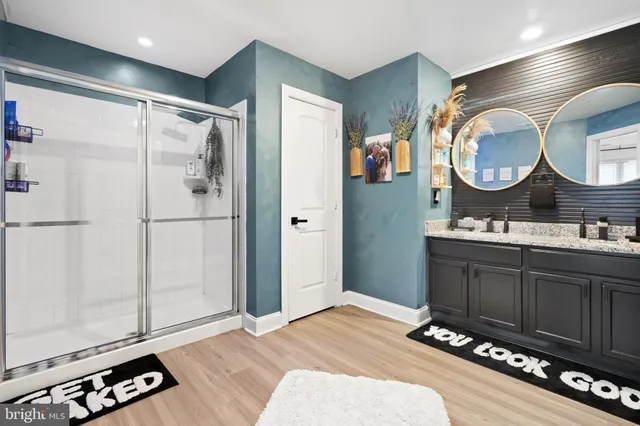 a bathroom with a double vanity sink and a mirror