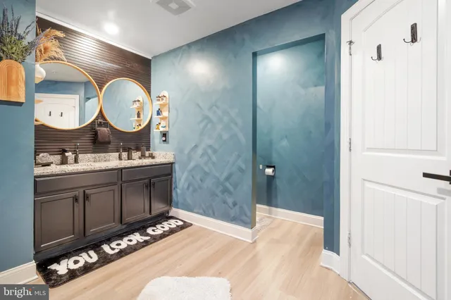 a bathroom with a sink mirror and vanity