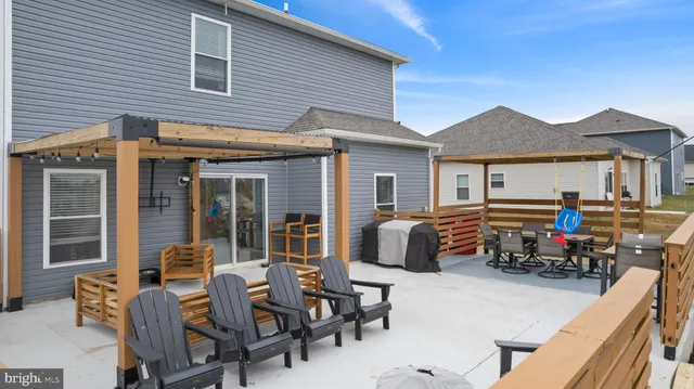 a view of a patio with couches chairs and potted plants